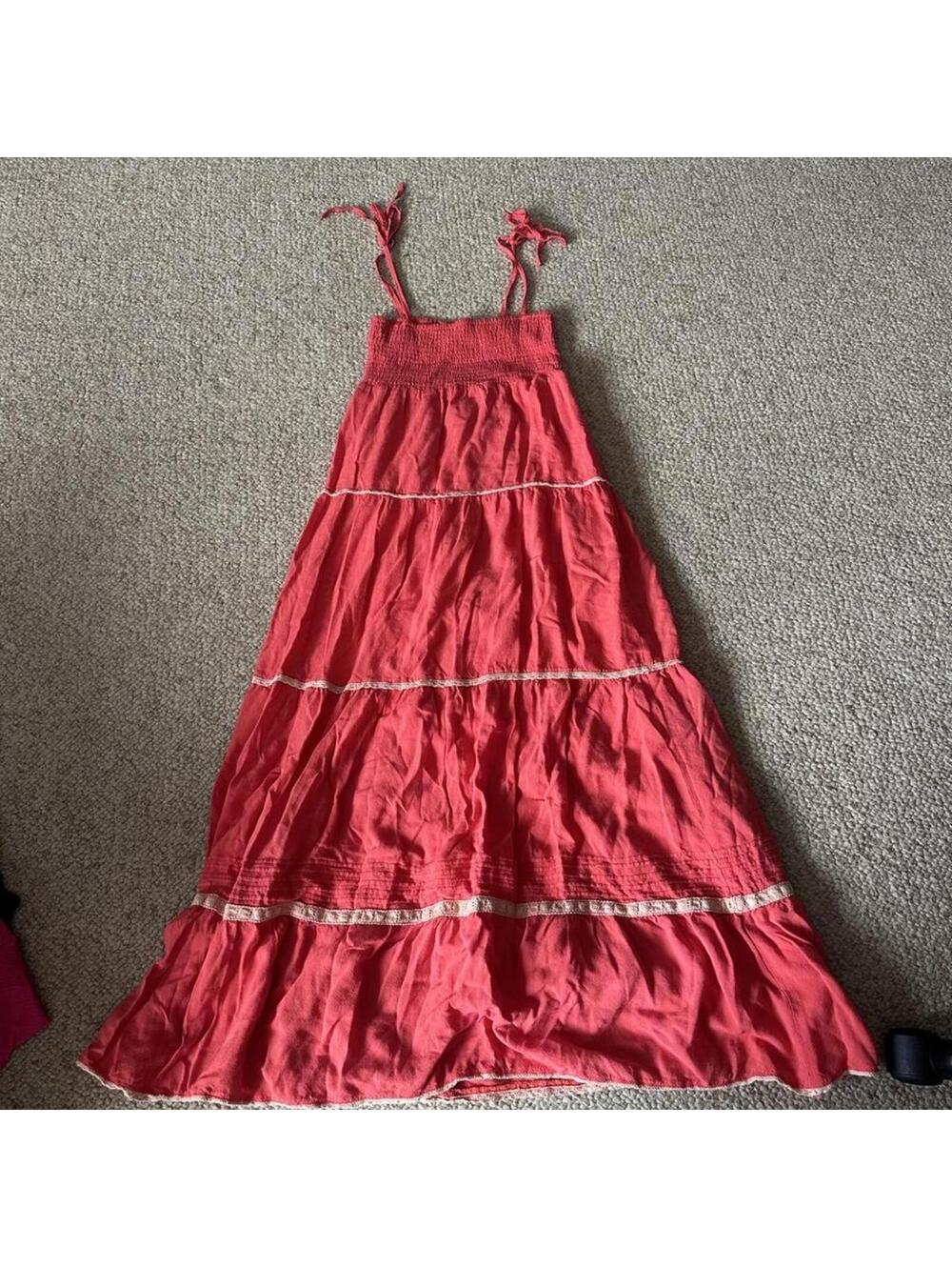 Red maxi dress with white lace trim and adjustable straps.